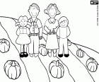 Een familie in het veld tijdens de val met de oogst van pompoenen